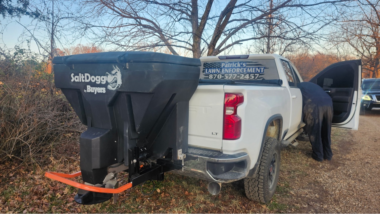 White Patrick's Lawn Enforcement truck equipped with a SaltDogg by Buyers salt spreader